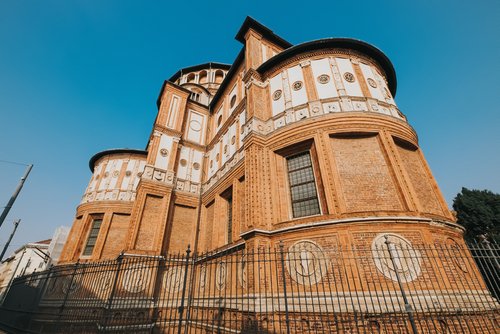 Back side of Church of Holy Mary of Grace (Chiesa di Santa Maria delle Grazie, 1497) A famous church for tourist in Milan, Italy, picture with grain film effect